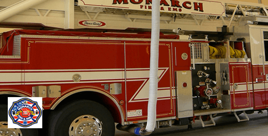 Overhead exhaust removal systems installed at a fire station to extract fire truck exhaust.