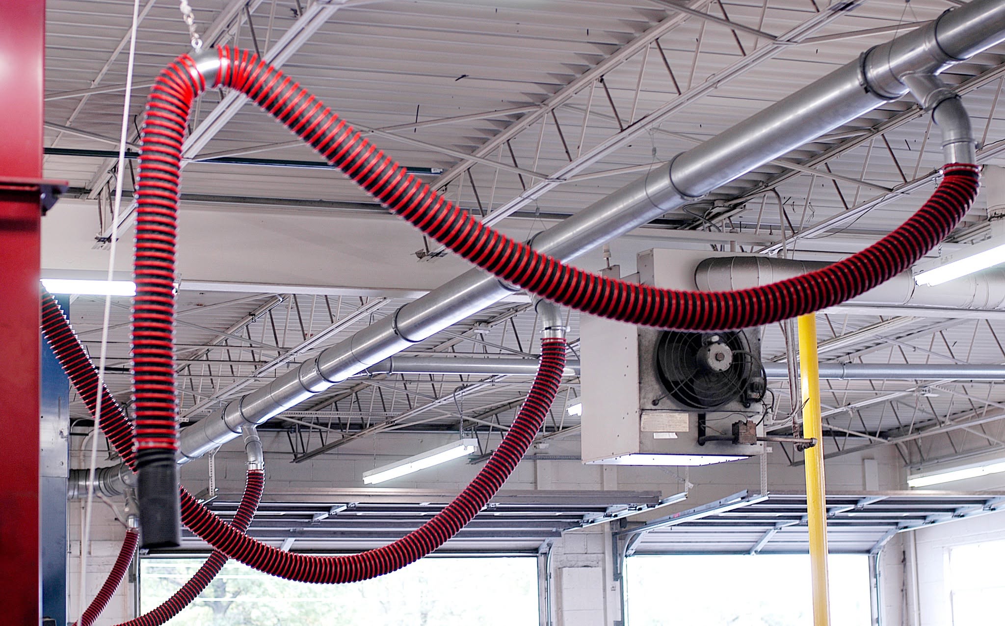 Rope and pulley exhaust removal system serving a service bay at Hollywood Motor Co.