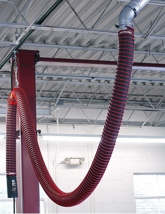 Fume-A-Vent vehicle exhaust hose installed in a repair garage.