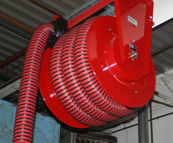 Hose reel shown installed in an auto repair and maintenance workshop.