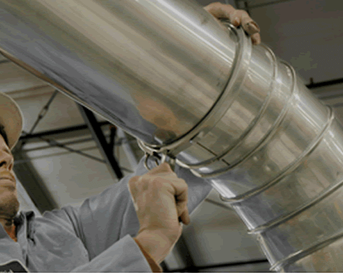 A technician installing slip-fit vehicle exhaust ducting.