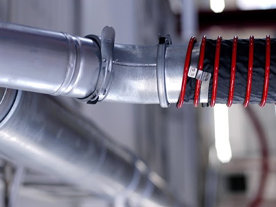 Fume-A-Vent vehicle exhaust ducting installed in an auto repair shop.