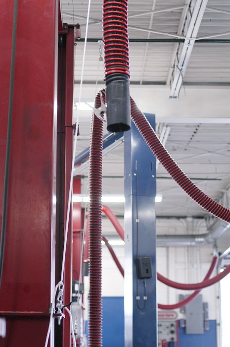 Overhead exhaust removal systems installed in a repair and maintenance facility to extract emissions.