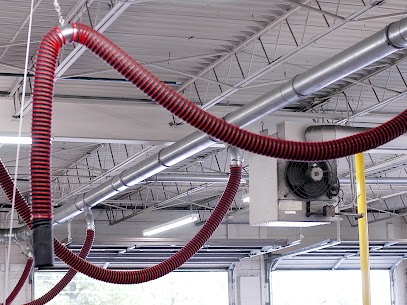 Rope and pulley overhead exhaust removal systems shown installed in a vehicle repair and maintenance facility.
