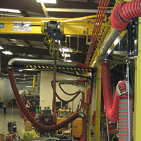 Fume-A-Vent Boom Arms shown installed to remove tractor exhaust at Diesel Power Equipment.