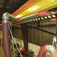 Boom Arms installed to remove tractor exhaust from a diesel engine repair shop.