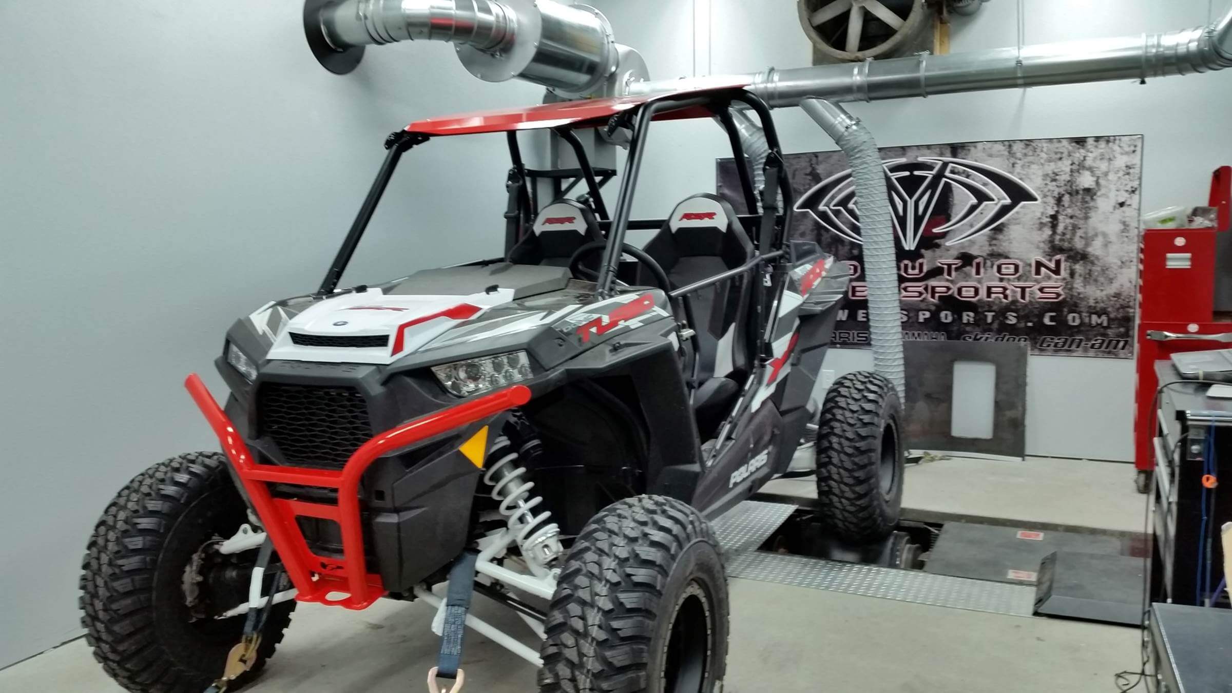 ATV attached to dyno exhaust removal system.